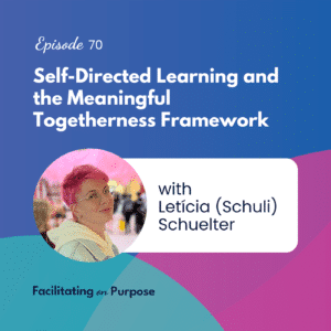 Letícia is a Brazilian woman with pink hair and glasses, looking sideways at the camera